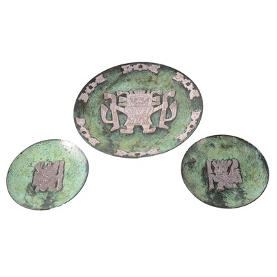 Lot 64 - Peruvian white metal overlaid patinated copper wall plaque and two plates, by Vichy