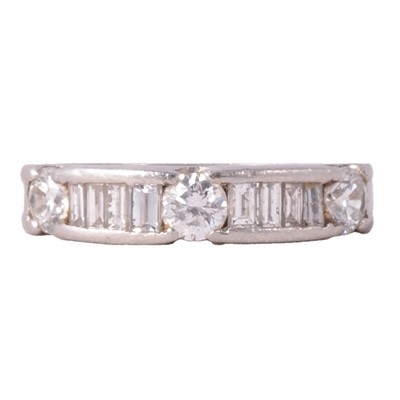 Lot 102 - A diamond half eternity ring.