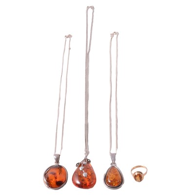 Lot 334 - A citrine ring, and three amber pendants on chains.