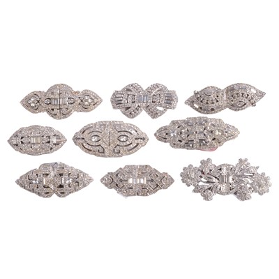 Lot 521 - Nine clear paste duette dress clips with brooch fittings.