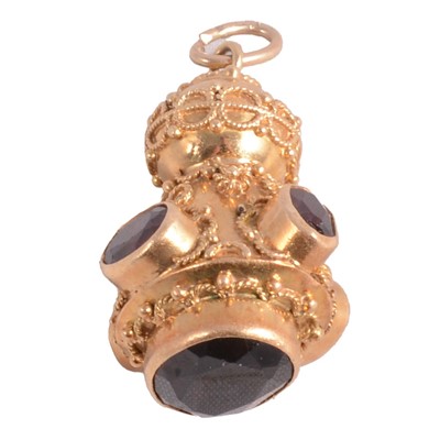 Lot 322 - An Italian Etruscan revival charm/pendant, circa 1970's, set with garnet.