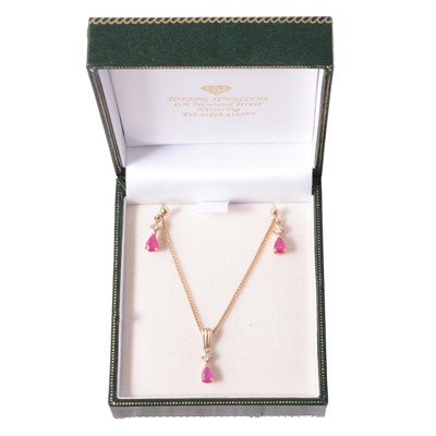 Lot 319 - A ruby and diamond pendant and earrings suite of jewellery.