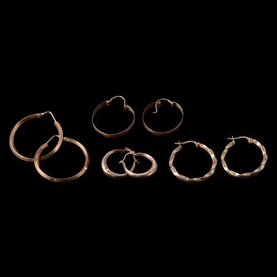 Lot 337 - Four pairs of yellow metal hoop earrings for pierced ears.