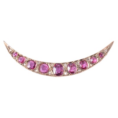 Lot 240A - A ruby and diamond open crescent brooch.