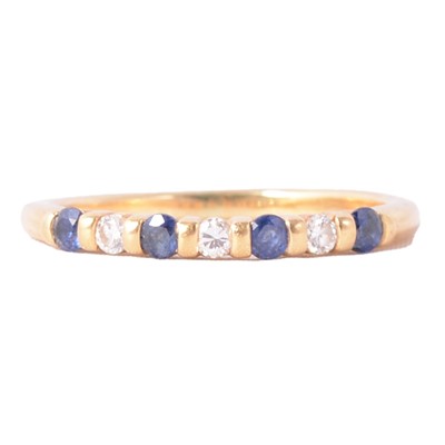 Lot 18 - A sapphire and diamond half eternity ring.