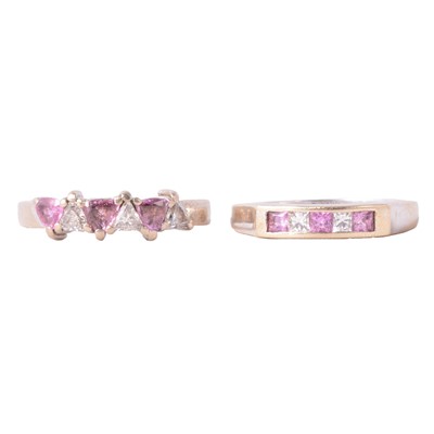 Lot 53 - Two pink/mauve and diamond half hoop rings.