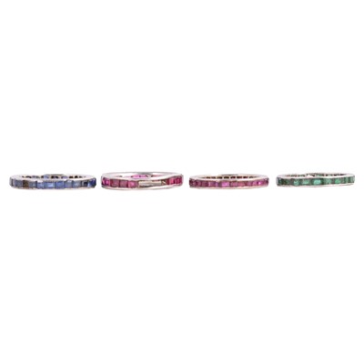Lot 61 - Four gemset full eternity rings, ruby, sapphire and emerald coloured stones.