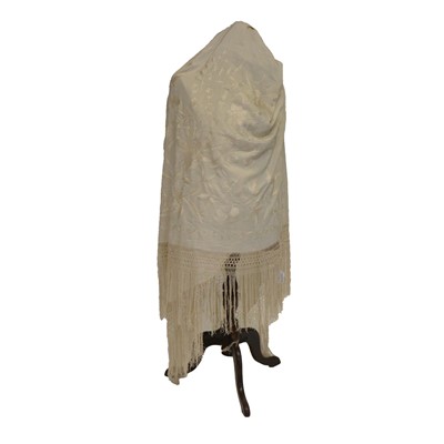 Lot 548 - A 19th century embroidered cream shawl.