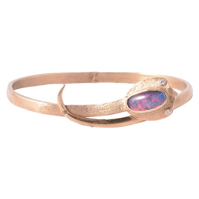 Lot 278 - A contemporary snake design bangle set with an opal triplet.
