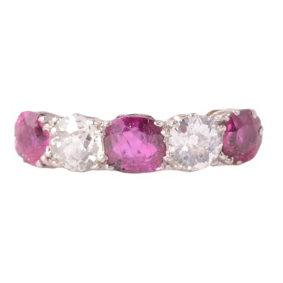 Lot 38 - A ruby and diamond half hoop ring.