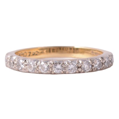 Lot 69 - A diamond half eternity ring.