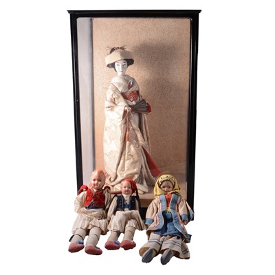 Lot 171 - Large Japanese Geisha doll in display case, and three Greek travel dolls