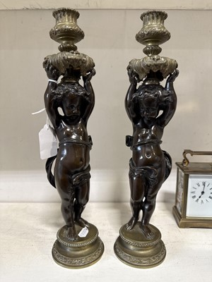 Lot 75 - Pair of bronze and cast brass figural candlesticks