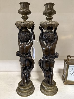Lot 75 - Pair of bronze and cast brass figural candlesticks
