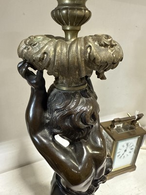 Lot 75 - Pair of bronze and cast brass figural candlesticks