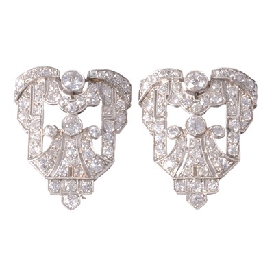 Lot 199 - A pair of Art Deco Odeon style diamond brooches.