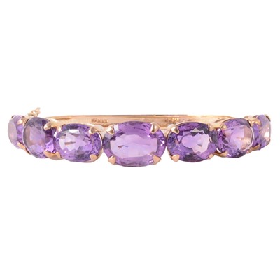 Lot 279 - An amethyst half hinged bangle.