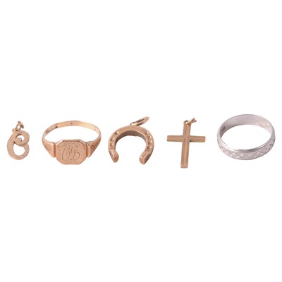 Lot 304 - A platinum wedding band, gold signet ring, and three gold charms.