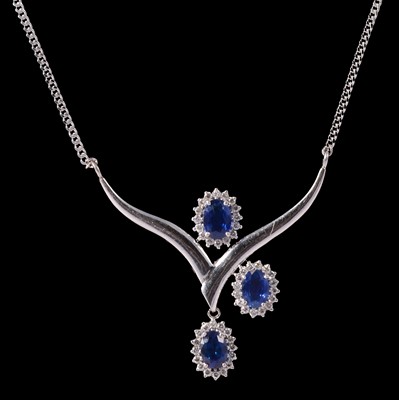 Lot 328 - A natural sapphire and diamond triple cluster necklace.