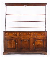 Lot 438 - George III oak dresser, three shelf delft rack...