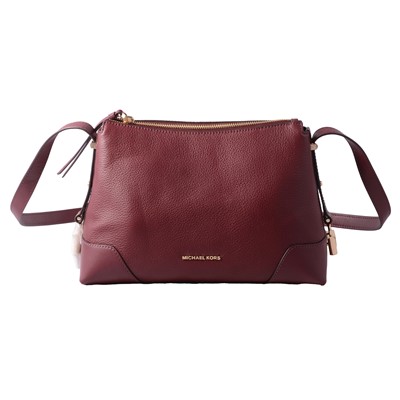 Lot 505 - Michael Kors - an oxblood burgundy leather handbag.
