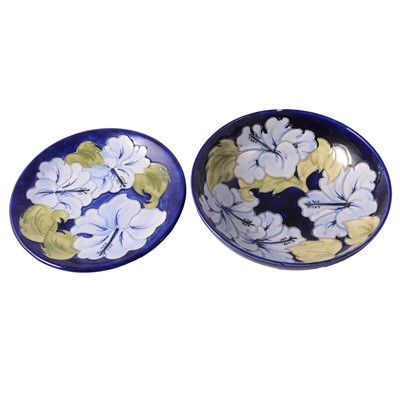 Lot 29 - Moorcroft Pottery, a 'Hibiscus' pattern bowl and plate, 1970s