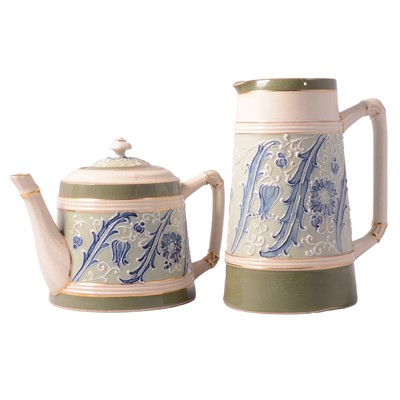 Lot 36 - James Macintyre 'Gesso Faience' ware teapot and hotwater jug, the design attributed to William Moorcroft