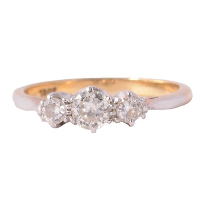 Lot 52 - A diamond three stone ring.