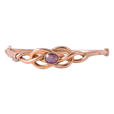 Lot 297 - An amethyst and yellow metal half hinged bangle.
