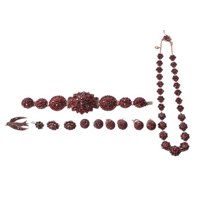 Lot 1156 - A garnet necklace, bracelet, earrings, brooch, and buttons in closed back settings.