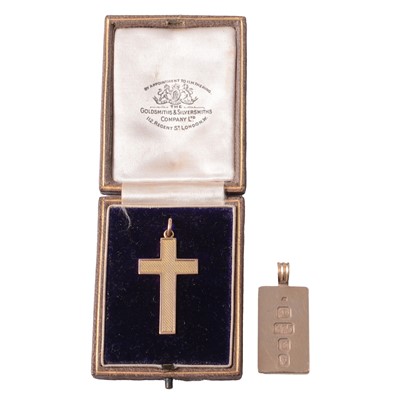 Lot 234 - A yellow metal cross pendant, and a 9 carat yellow gold ingot pendant.