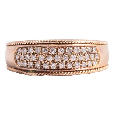 Lot 100 - A three row diamond half hoop ring.