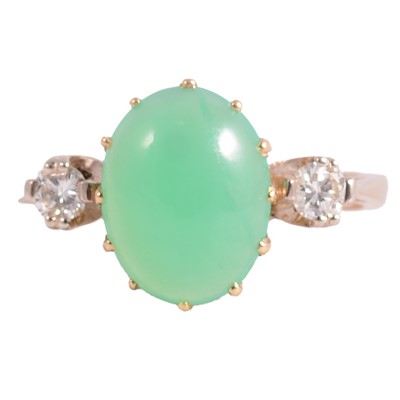 Lot 14 - A diamond and green stone ring.