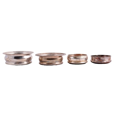 Lot 385 - Three silver bottle coasters, and a silver-plated bottle coaster.