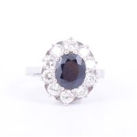 Lot 174 - A sapphire and diamond oval cluster ring, an...