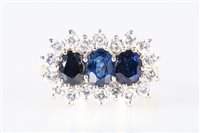 Lot 175 - A sapphire and diamond cluster ring, three...