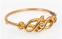 Lot 213 - A yellow metal knot design bangle, 4mm wide...