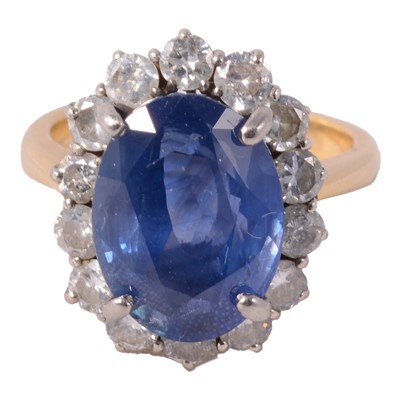 Lot 42 - A sapphire and diamond cluster ring.