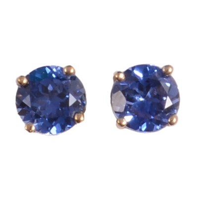 Lot 438 - A pair of blue stone solitaire earrings.