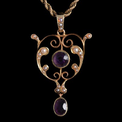 Lot 382 - An Edwardian amethyst and seed pearl pendant on a chain.