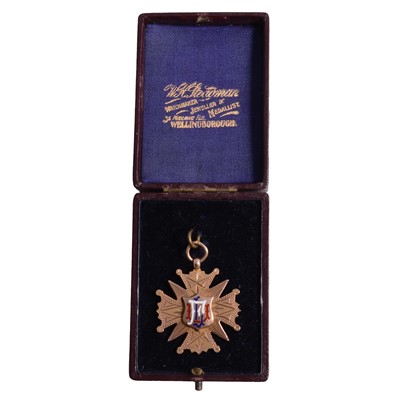 Lot 221 - Football interest - an early 20th century 9 carat yellow gold and enamel football medal.