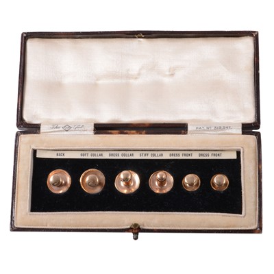 Lot 472 - A set of six yellow metal dress studs, cased.