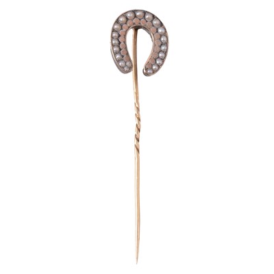 Lot 481 - A seed pearl and coral horseshoe stick pin.