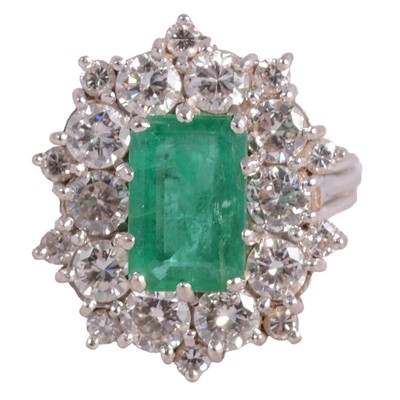 Lot 3 - An emerald and diamond cluster ring.