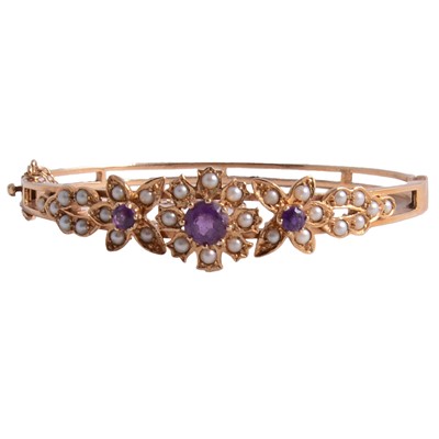Lot 276 - An amethyst and seed pearl bangle in the Victorian style.