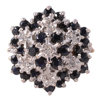 Lot 9 - A sapphire and diamond cluster ring.