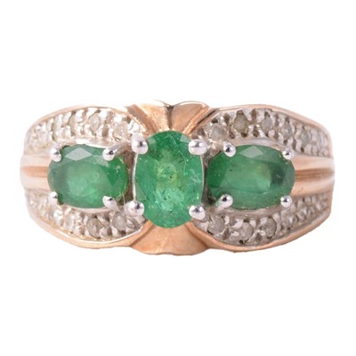 Lot 6 - An emerald and diamond ring.