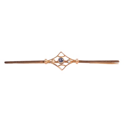 Lot 255 - A sapphire and seed pearl bar brooch.