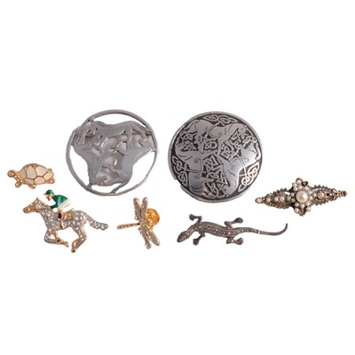 Lot 1295 - A collection of silver, white metal, and costume jewellery pendants, brooches, and other items.