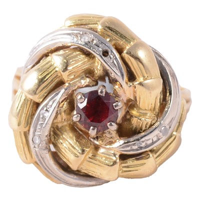 Lot 27 - A gem set yellow and white metal swirl ring.